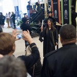 Vanessa Larrick waves her diploma as her mother Martha takes her photograph.