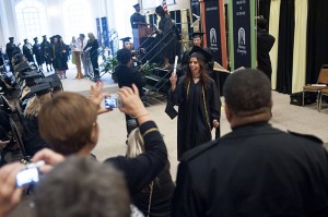 Vanessa Larrick waves her diploma as her mother Martha takes her photograph.