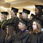 Students stand during the conferring of degrees portion of Saturday's undergraduate and graduate commencement services