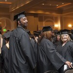Christopher Carpenter, left, looks back to the crowd as students file into the First Baptist Church banquet hall for the undergraduate and graduate commencement services Saturday.