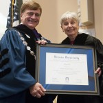 Brenau University President Ed Schrader presents commencement speaker Eleanor Clift with an honorary degree of Doctor of Humane Letters before she addressed the 2013 graduating students in the undergraduate and graduate programs Saturday.