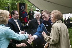 Brenau University President Ed Schrader shakes hands with the family of Richard and Phyllis Leet, who were given honorary degrees for community service and service to Brenau during the 2013 commencement ceremonies. Richard Leet is a Brenau Trustee.