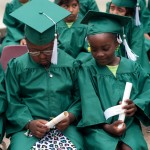 Zayia Young, left, and Zyriea Tripp look over their diplomas during the RISE graduation.