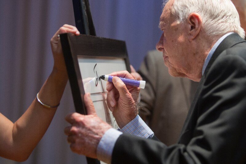 Former President Jimmy Carter signed Brenau University's print of a Jimmy Carter portrait done by Andy Warhol after his question and answer session with the school's first-year students.