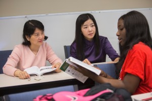 Lixin Zhu and Yan Zhou of Anhui Normal College in Anhui, China, work with first year student Tiffany Ozieh during Dr. Sonia Robles history class.