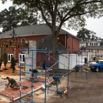 Crews from All Outdoor lay pavers beneath the former entry sign to the Brenau Women's College which will now serve as the gateway to a new greenspace on the site of the former Sorority Circle.