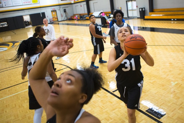 Jalyn Brown drives for a layup behind Kayla Mitchell during a drill at JV practice.