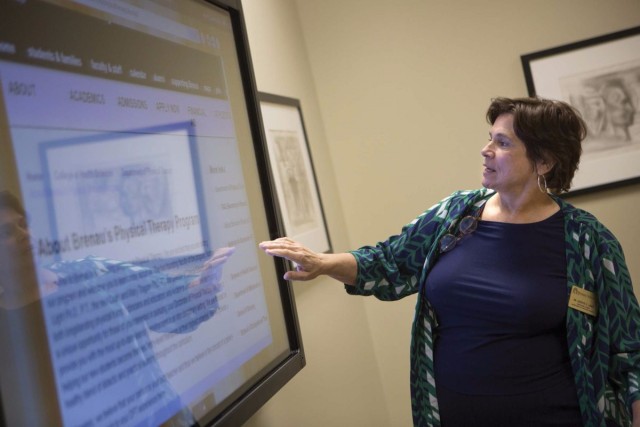 Kathye Light, chair of the Department of Physical Therapy, uses touch screen computer technology in a classroom just around the corner from her office from which she oversees a doctoral program that is expected to grow to 120 students.