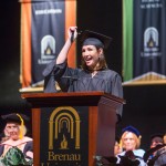 Brenau's executive director of alumni and constituent engagement leads her fellow Winter 2015 graduates in moving their tassels.