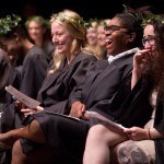 Senior students Dana Cole, second from right, and MK Jabbia laugh on the stage during the Class Day ceremony during the Brenau University Alumnae Reunion Weekend on Saturday, April 16, 2016, in Gainesville, Ga. (AJ Reynolds/Brenau University)