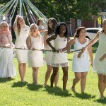 Women's College underclassmen carry an ivy and daisy draped rope while paying homage to the senior class on May Day, 2016 Alumnae Reunion Weekend