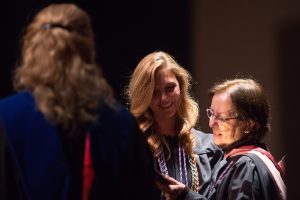 Elizabeth Huff, center, gets a hug after receiving the Ocie Rich Pope Award during the Brenau University School of Nursing Pinning Ceremony on Thursday, May 5, 2016 in Pearce Auditorium in Gainesville, Ga. (AJ Reynolds/Brenau University)