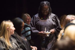 Fabienne McDonald walks back to her seat after receiving her lamp during the Brenau University School of Nursing Pinning Ceremony on Thursday, May 5, 2016 in Pearce Auditorium in Gainesville, Ga. (AJ Reynolds/Brenau University)