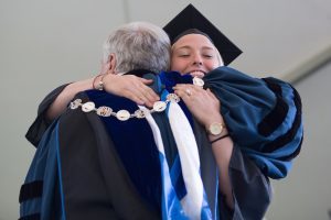 MK Jabbia hugs Brenau President Ed Schrader while receiving her degree during The Women's College Commencement on Friday, May 6, 2016, in Gainesville, Ga. (AJ Reynolds/Brenau University)