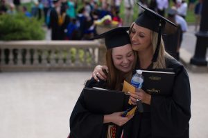 Emily Lemons, left, and Brittany Daniel, both WC '16, hug after The Women's College Commencement on Friday, May 6, 2016, in Gainesville, Ga. (AJ Reynolds/Brenau University)