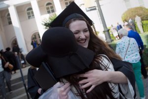 Kaitlyn Batchelor, WC '16, gets a hug after The Women's College commencement on Friday, May 6, 2016, in Gainesville, Ga. (AJ Reynolds/Brenau University)