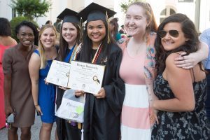 Graduates Denise Sunga, right, and Meg Bronaugh pose for a photo after The Women's College commencement on Friday, May 6, 2016, in Gainesville, Ga. (AJ Reynolds/Brenau University)