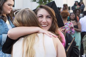 Lauren LaRicci, WC '16, gets a hug after The Women's College commencement on Friday, May 6, 2016, in Gainesville, Ga. (AJ Reynolds/Brenau University)