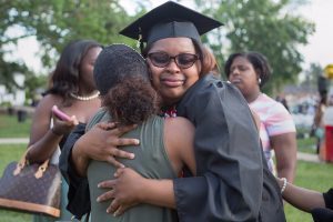 Quanesha Davis, WC '16, sheds a tear while getting a hug from Trae Candelario after The Women's College commencement on Friday, May 6, 2016, in Gainesville, Ga. (AJ Reynolds/Brenau University)