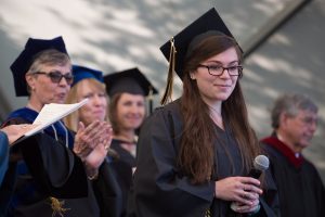 Rachel McFarland, WC '16, walks off stage after singing the National Anthem during The Women's College commencement on Friday, May 6, 2016, in Gainesville, Ga. (AJ Reynolds/Brenau University)