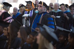 Stewart Blakley walks to the stage to accept the Vulcan Teaching Award during The Women's College commencement on Friday, May 6, 2016, in Gainesville, Ga. (AJ Reynolds/Brenau University)