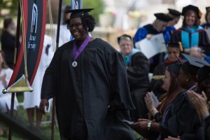 Portia Burns walks to the stage to accept one of two Outstanding Part-Time Faculty Awards during The Women's College commencement on Friday, May 6, 2016, in Gainesville, Ga. (AJ Reynolds/Brenau University)