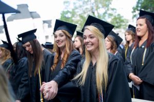 Logan Deyarmin, right and Alaina Troha, both WC '16, hold hands during The Women's College commencement on Friday, May 6, 2016, in Gainesville, Ga. (AJ Reynolds/Brenau University)