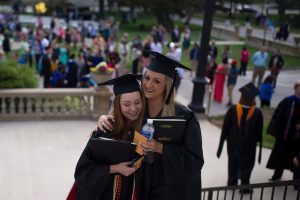 Emily Lemons and Brittany Daniel, both WC '16, hug during The Women's College commencement on Friday, May 6, 2016, in Gainesville, Ga. (AJ Reynolds/Brenau University)