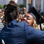 Kia Howell, an early childhood education graduate, gets a hug after the Brenau University Undergraduate and Graduate Commencement on Saturday, May 7, 2016, in Gainesville, Ga. (AJ Reynolds/Brenau University)
