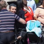 Patrick Condon, BU '16, gets a hug after the Brenau University Undergraduate and Graduate Commencement on Saturday, May 7, 2016, in Gainesville, Ga. (AJ Reynolds/Brenau University)