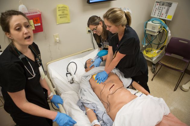 Kaelan Schultz, from left, Alicia Koredjian and Elizabeth Huff treat a trauma patient in the Brenau Nursing Sim Lab on Tuesday, April 12, 2016, in Gainesville, Ga. (AJ Reynolds/Brenau University)