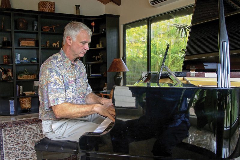 Christopher Culp, fleet surgeon for the United States Pacific Fleet, plays the piano inside his home.