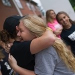 Sarah Jane Bowers, center, gets a hug from Micah Rhodes outside of Crudup Hall. (AJ Reynolds/Brenau University)