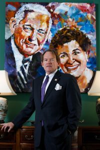 Frank Norton Jr., chairman and CEO of the Norton Agency, poses for a portrait in front of a painting of his parents Frank and Betty Norton painted by Steve Penley. Norton recently joined the Brenau Board of Trustees, and his mother, Betty, is also a member of the board. (AJ Reynolds/Brenau University)