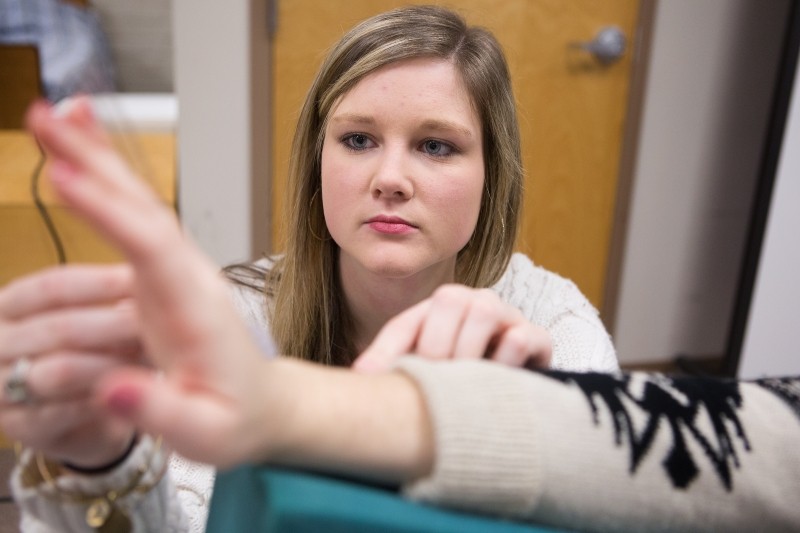 Morgan Meadows tests the range of motion of her classmate Haley Fain's wrist during an occupational therapy lab. (AJ Reynolds/Brenau University)