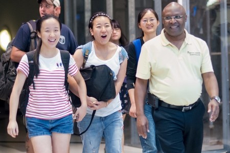 From left, Crystal Wang, Cathy Wu, Daisy Qiu and College of Education Dean Eugene Williams walk into the arrivals area at Hartsfield-Jackson International Airport in Atlanta. (AJ Reynolds/Brenau University)