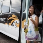 Lisa Wang walks off the bus with items she bought for her residence. (AJ Reynolds/Brenau University)