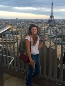 Madison Kosater poses for a photo near the Eiffel Tower in Paris.