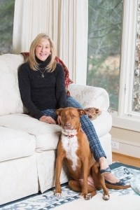 Brenau Trustee Amy Whitley seated with her dog. (AJ Reynolds/Brenau University)