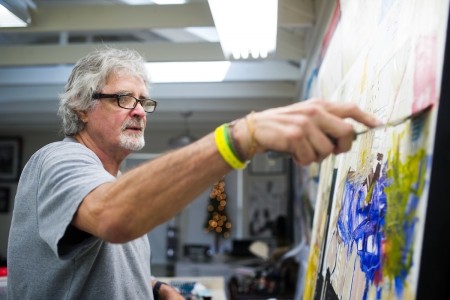 Dennis Campay paints in his studio in Jacksonville, Fla. (AJ Reynolds/Brenau University)