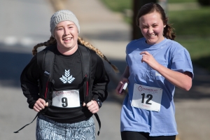 Sara Jane Bowers, left, and Brittany Brookins cross the finish line during the Dempsey Dash 5K, a race celebrating the memory of Brenau's longtime Executive Vice President and CFO Wayne Dempsey, on Saturday, March 11, 2017. (AJ Reynolds/Brenau University)