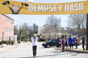 Wright Dempsey poses for a photo under the starting banner after the Dempsey Dash 5K, a race celebrating the memory of Brenau's longtime Executive Vice President and CFO Wayne Dempsey, on Saturday, March 11, 2017. (AJ Reynolds/Brenau University)