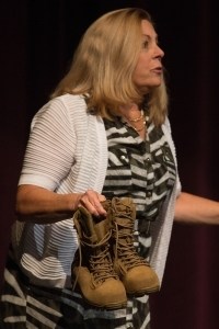 Patricia Wolfe pulls out a pair of combat boots during her speech during the 4th Annual Women's Leadership Colloquium on Friday, March 17, 2017. (AJ Reynolds/Brenau University)