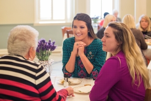 Allie Smith and Hannah Vigil-Shuck, right, listen as Janis Wilson, a former home economics instructor at Brenau, speaks with them during the Back to Campus Luncheon. (AJ Reynolds/Brenau University)