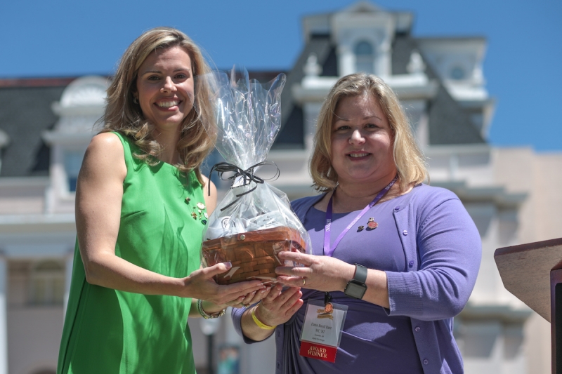 Brooke Statham, WC '00, presents Dana Boyd Barr, WC '87, a gift basket during the 2017 Alumnae Reunion Weekend at Brenau University, Saturday, April 08, 2017. Barr has been inducted into the Alumnae Hall of Fame. (Photo/ John Roark for Brenau University)