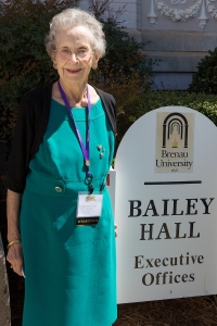 Cathryn V. Cook, WC '49 poses for a photo by the Bailey Hall sign. During her time at Brenau, Cook lived in the hall. (AJ Reynolds/Brenau University)