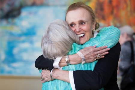 Paige Houseman, WC '66, gets a hug from Judy Davis Alexander, WC '67, before the dinner for the dinner for the 50th anniversary with the Brenau Trustees. (AJ Reynolds/Brenau University)