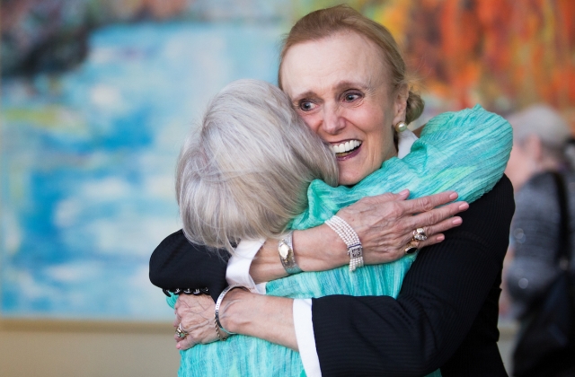 Paige Houseman, WC '66, gets a hug from Judy Davis Alexander, WC '67, before the dinner for the dinner for the 50th anniversary with the Brenau Trustees. (AJ Reynolds/Brenau University)