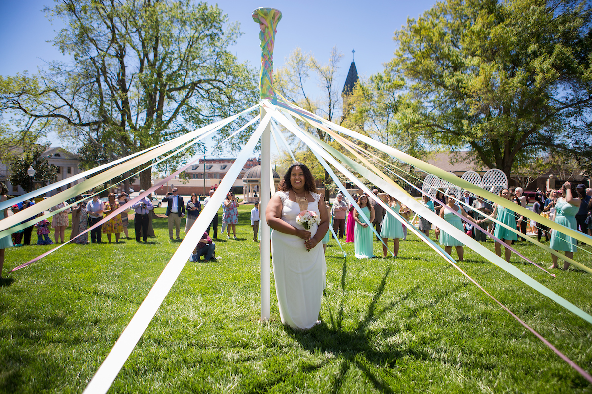 May Queen Sara Hubaishi stands under the May Pole. (AJ Reynolds/Brenau University)
