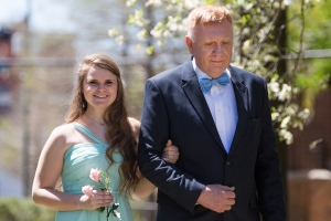 Megan Bullins, left, is escorted by her grandfather, Phillip Iddings as they process from the Daniel Pavilion to take her place on the May Court. (AJ Reynolds/Brenau University)